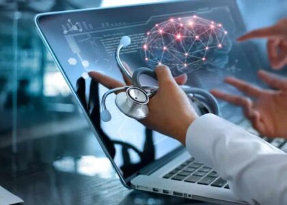 A man works at a laptop computer with a picture of a brain